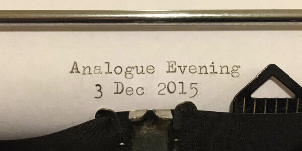 Typewriter and paper displaying “An Analogue Evening”